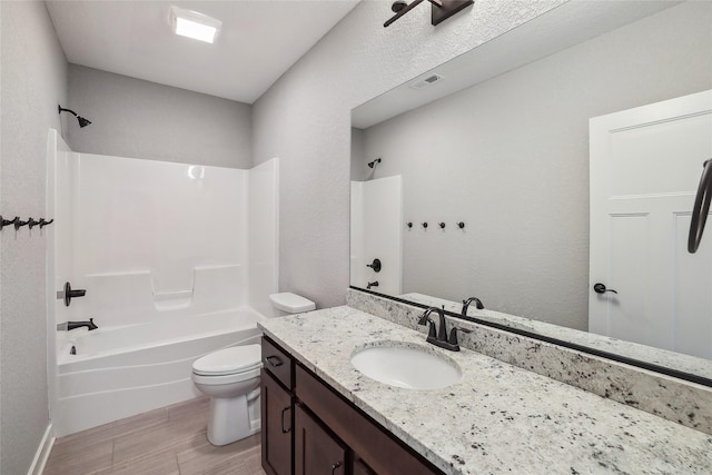 bathroom with toilet, wood finished floors, bathing tub / shower combination, vanity, and visible vents