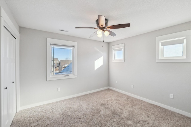 unfurnished bedroom with carpet floors, a closet, visible vents, and baseboards