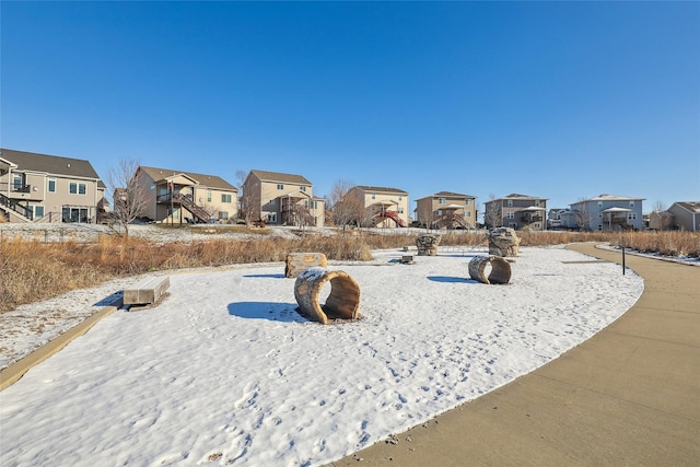 yard layered in snow featuring a residential view