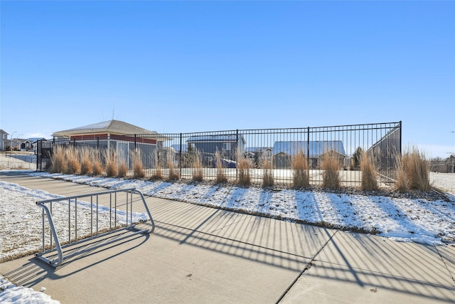 snow covered pool with fence