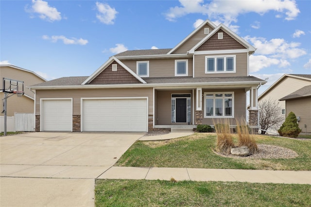 100 Abigail Ln, Waukee, IA 50263 - craftsman-style home featuring an attached garage, driveway, a front yard, covered porch, and stone siding