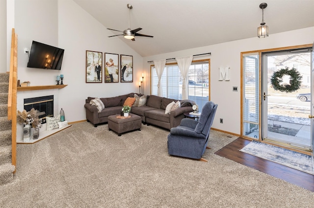 carpeted living room with lofted ceiling and ceiling fan