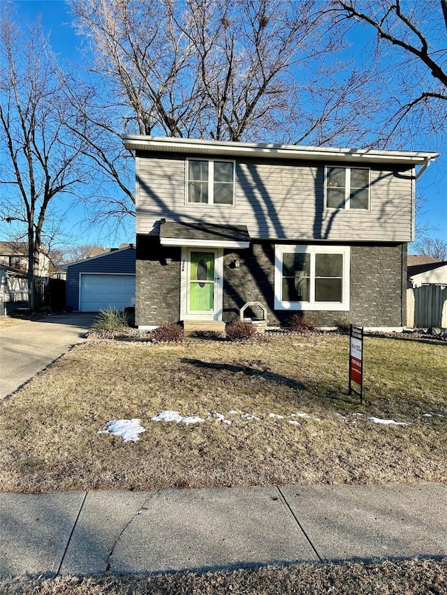 front facade with a garage and a front lawn