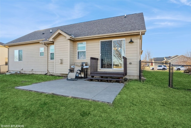 rear view of property featuring a lawn and a patio area