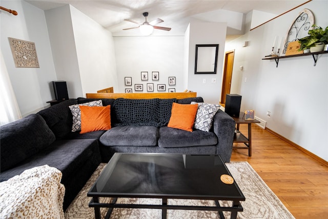 living room featuring ceiling fan, wood-type flooring, and vaulted ceiling