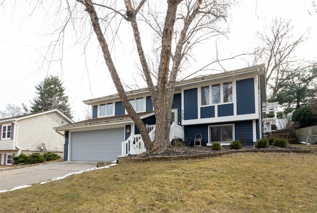 view of front of property with a garage and a front lawn