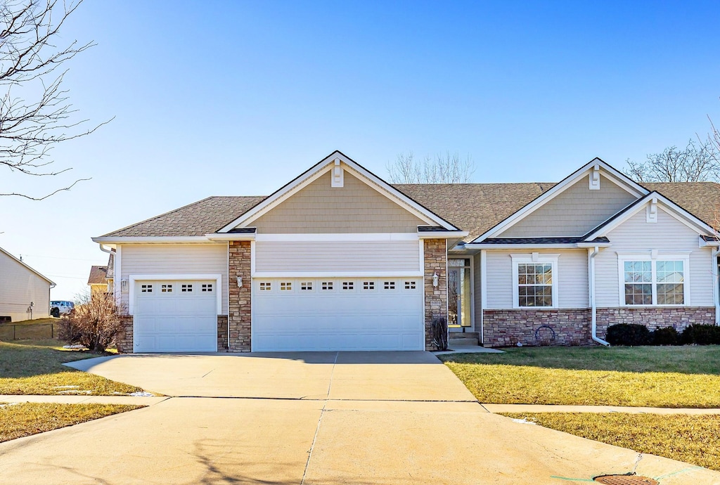 craftsman-style home with a front lawn and a garage