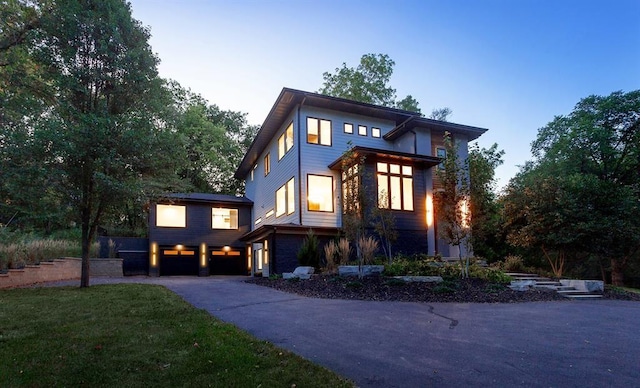 view of front of property featuring a garage and a yard