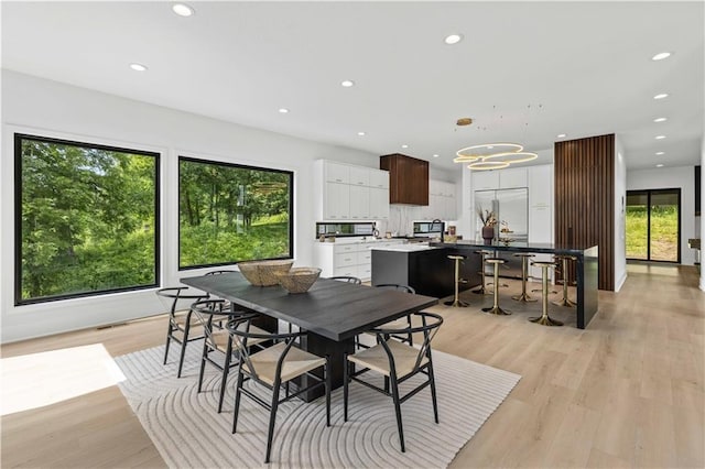 dining room featuring a notable chandelier and light hardwood / wood-style floors