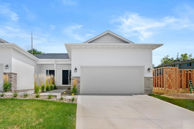 view of front of property with a front yard and a garage