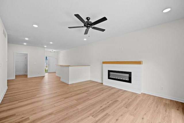 unfurnished living room with ceiling fan and light hardwood / wood-style floors