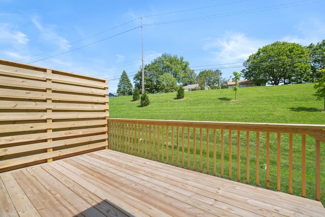 wooden deck featuring a yard