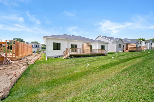 back of house with a wooden deck and a lawn