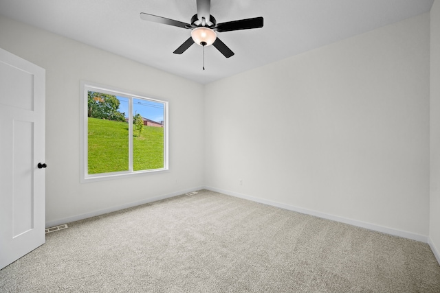 carpeted spare room with ceiling fan