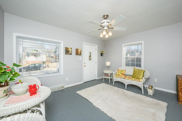 living area with ceiling fan and a healthy amount of sunlight