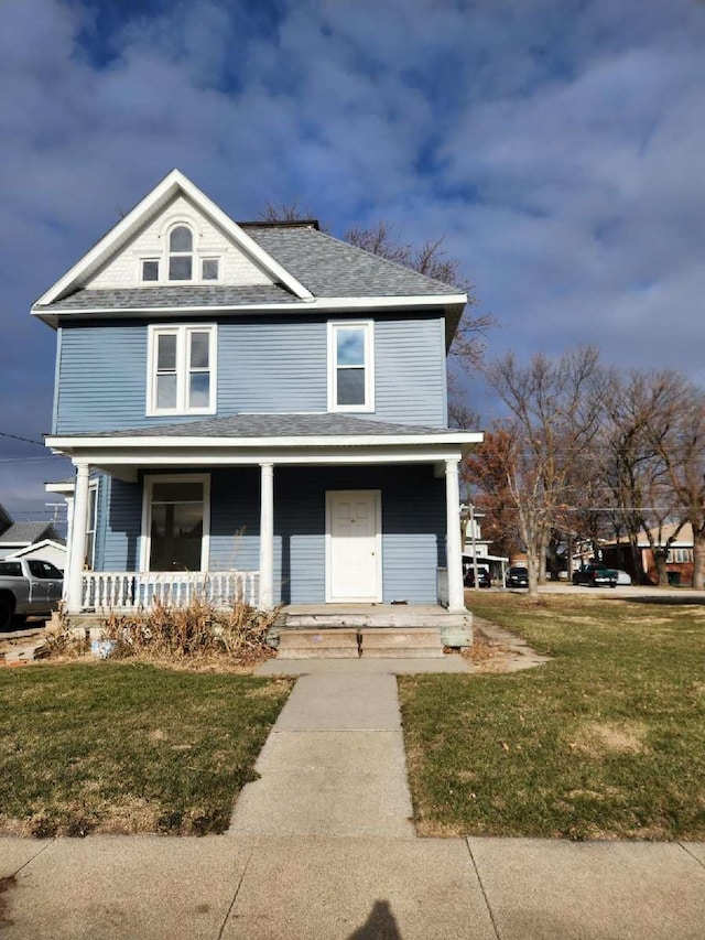 view of front of home featuring covered porch and a front lawn