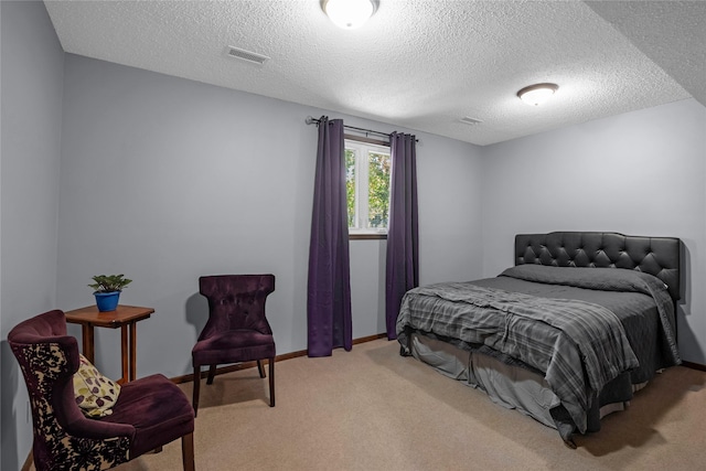 bedroom with carpet floors and a textured ceiling