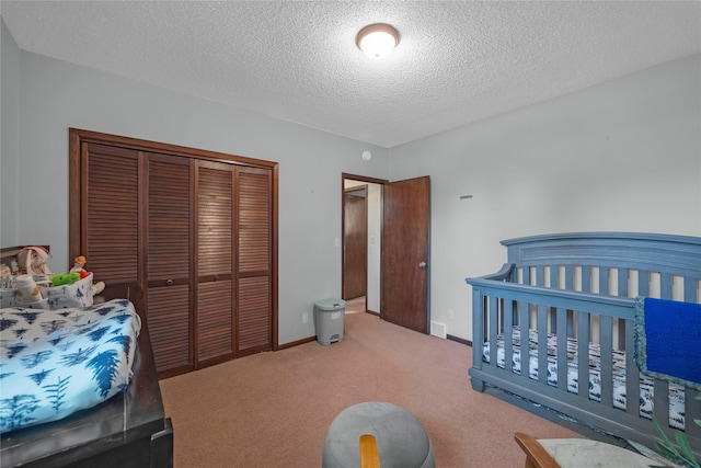 bedroom featuring carpet, a textured ceiling, and a closet