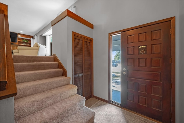 foyer entrance featuring light carpet