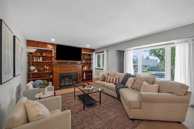 living room with a textured ceiling and wood walls