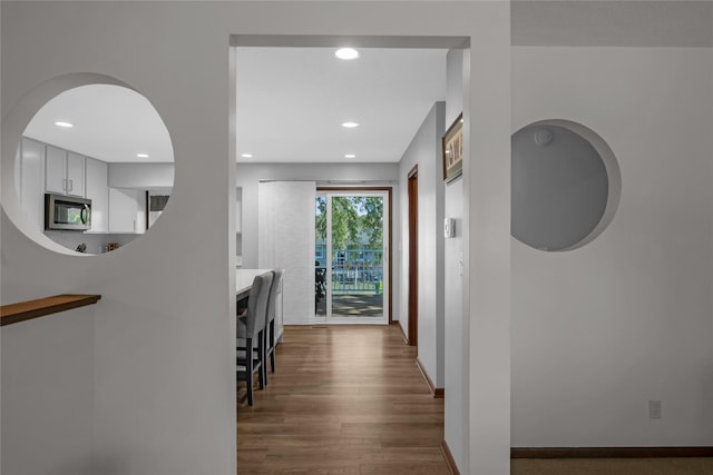 hallway with dark hardwood / wood-style flooring