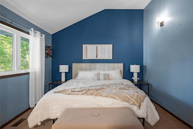 carpeted bedroom with vaulted ceiling