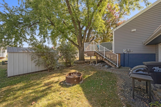 view of yard with a fire pit and a storage shed