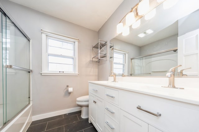 full bathroom featuring shower / bath combination with glass door, tile patterned floors, vanity, and toilet