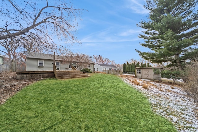 view of yard with a deck and a storage shed