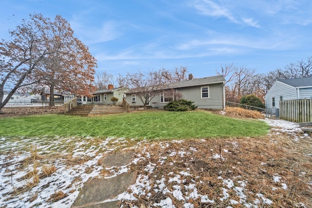 snow covered property featuring a lawn