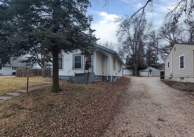 view of side of property with a garage and an outdoor structure