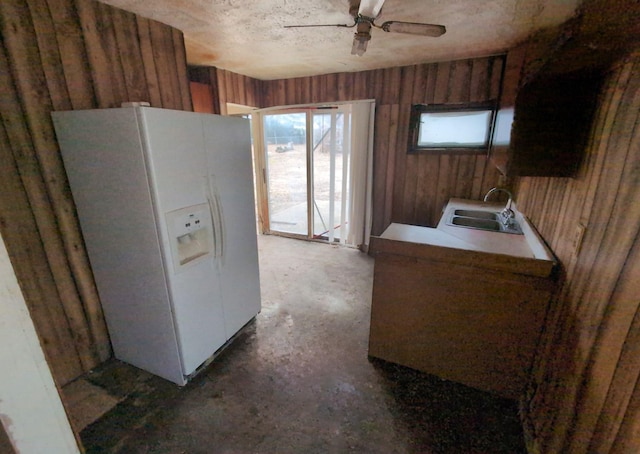 kitchen featuring sink, ceiling fan, and white refrigerator with ice dispenser