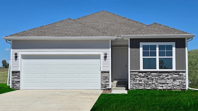 view of front of house with a garage, stone siding, concrete driveway, roof with shingles, and a front yard