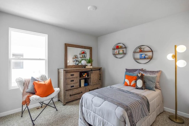 bedroom featuring baseboards and light colored carpet