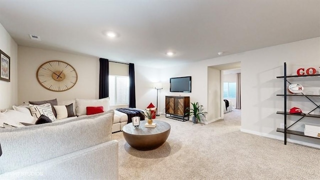 carpeted living area with recessed lighting, visible vents, and baseboards