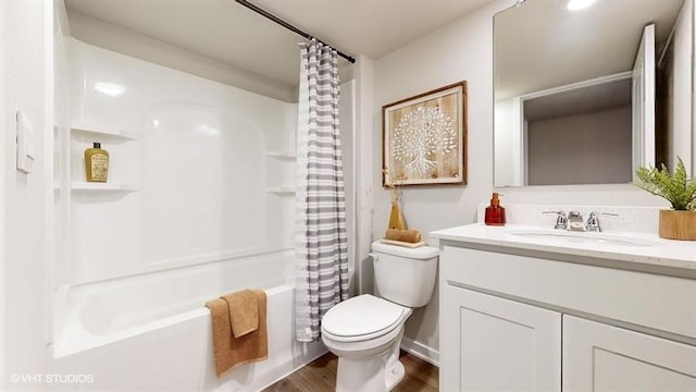 bathroom with wood finished floors, vanity, toilet, and shower / bathtub combination with curtain