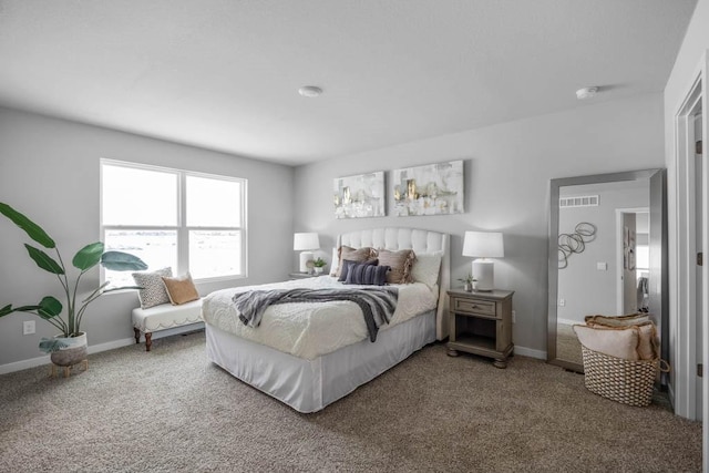 carpeted bedroom featuring visible vents and baseboards