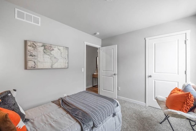 bedroom featuring carpet floors, visible vents, and baseboards