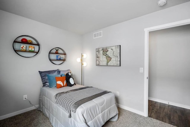 bedroom featuring visible vents and baseboards