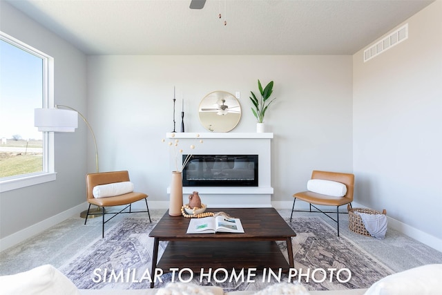 living room featuring carpet and plenty of natural light