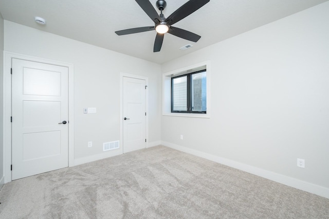 unfurnished bedroom featuring carpet floors and ceiling fan