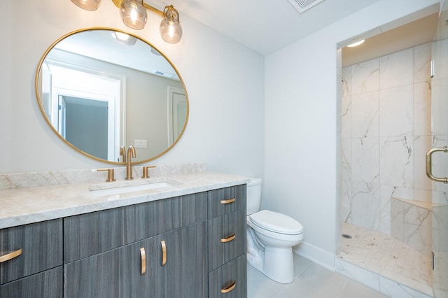 bathroom featuring tiled shower, vanity, toilet, and tile patterned flooring