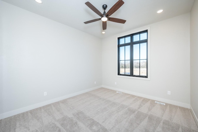 carpeted empty room featuring ceiling fan