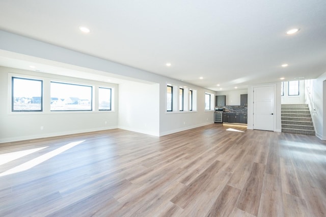 unfurnished living room with light wood-type flooring