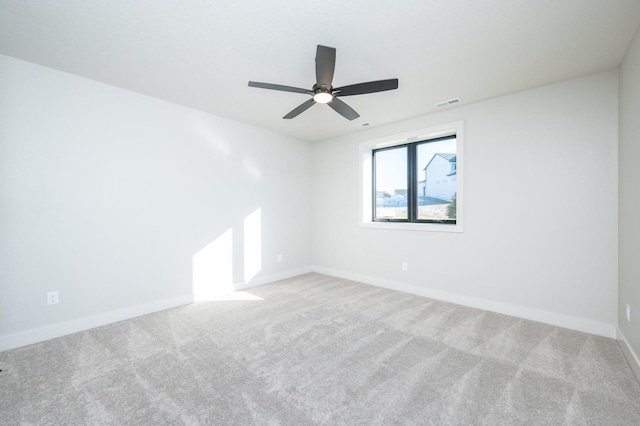 carpeted empty room featuring ceiling fan