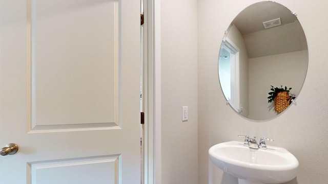 bathroom with visible vents and a sink