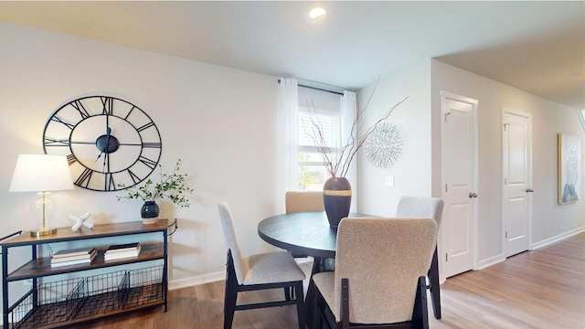 dining area featuring baseboards and wood finished floors