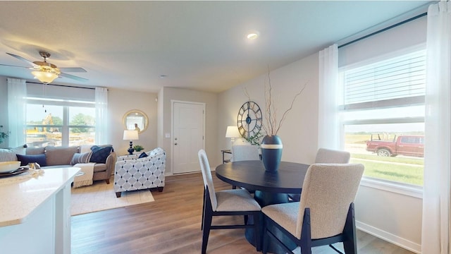 dining area featuring a ceiling fan and light wood-style flooring