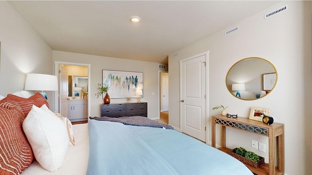 bedroom featuring visible vents and ensuite bathroom