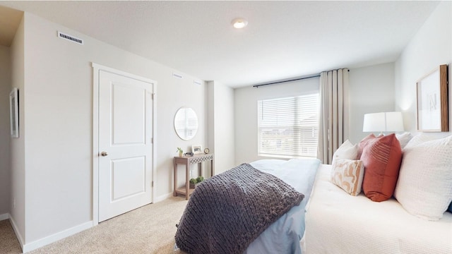 bedroom with carpet, visible vents, and baseboards